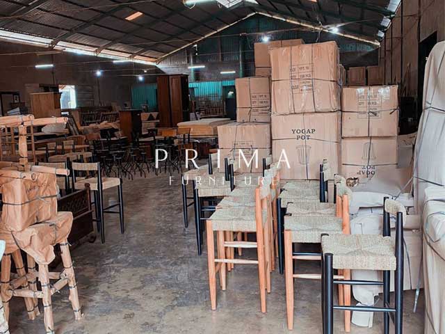 Export container loading of wrapped and boxed teak furniture orders at Jepara facility